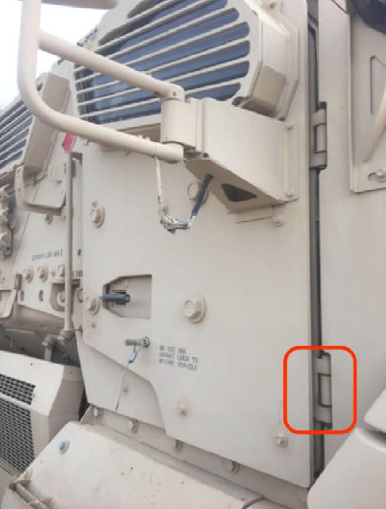 A picture of the cab door hinge on an Army MRAP vehicle